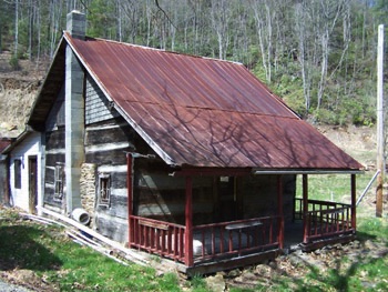 BLANTON/REECE LOG CABIN 



-  Dated to 1821, the structure is considered to be Haywood County’s oldest log cabin. The cabin’s full-dovetail corner mortise is a rare architectural feature of this English-style single-unit with shed addition. This 360 square foot cabin was home to ten members of the Vess and Talitha Reece family from 1925-2001.  Book 5 of <i>Legends, Tales & History of Cold Mountain</i> recounts vivid details about the Reece family as captured from the memory of Reece descendants. Speculation about the Blanton heritage is outlined in Book 6 of the <i>Legends</i> series.